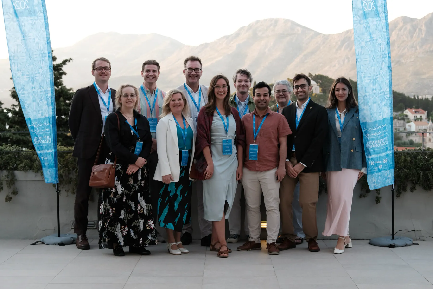 The Systems Engineering Design group together at the International Design Conference, with mountains behind them